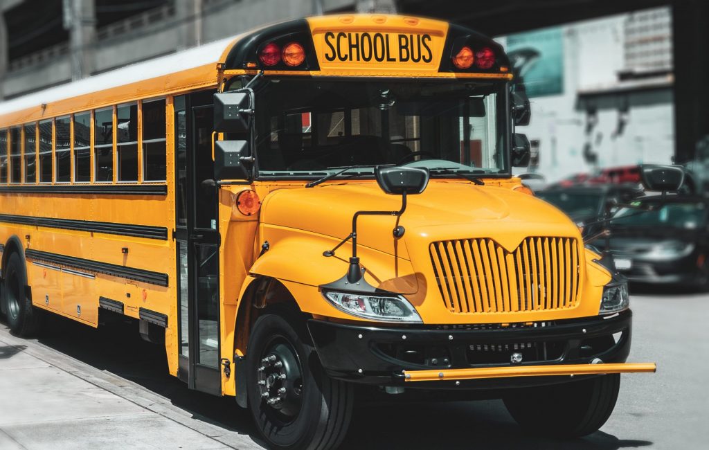 American schoolbus parked in the street. Vintage look and blurred edges.